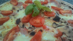 Pizza with mozzarella and tomatoes Ham Mushrooms