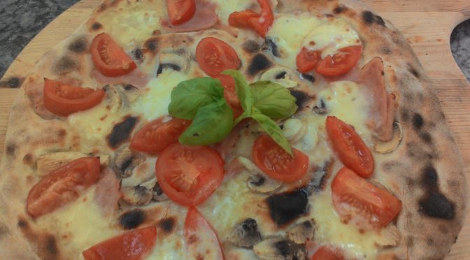 Pizza with mozzarella and tomatoes Ham Mushrooms