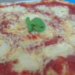 Pizza with salami and Edam cheese