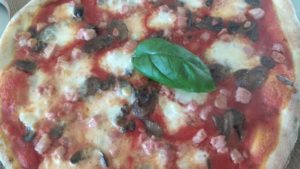 Pizza With Tomato Mozzarella Pancetta and Mushrooms