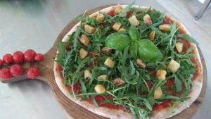 Pizza with anchovies, rocket and potatoes