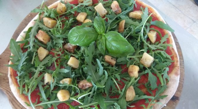 Pizza with anchovies, rocket and potatoes