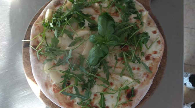 Pizza with mozzarella, gorgonzola, pears and rocket