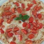 Pizza with Mozzarella Bacon and Cherry Tomatoes